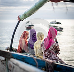 Group of Muslim girls together on beach