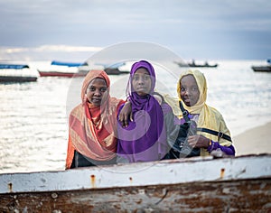 Group of Muslim girls together on beach