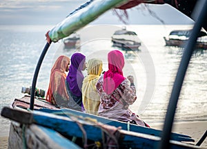 Group of Muslim girls together on beach