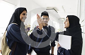 A group of Muslim students doing hi-5