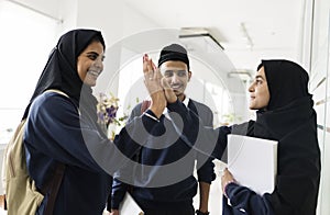 A group of Muslim students doing hi-5 photo