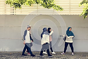 A group of Muslim students walking on the street photo
