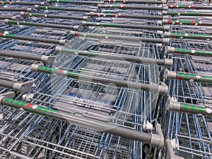 Group of new shopping carts in a store close-up. Retailing in a supermarket