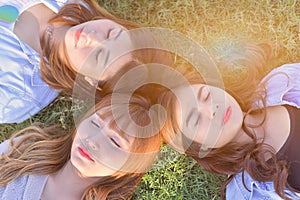 Group o beautiful girl are laying on the sunny glade with smail an