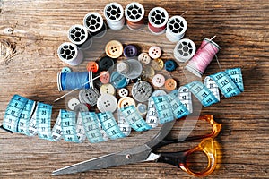 Group of objects about Sewing equipment set on a wooden background. Sewing and tailoring concept.