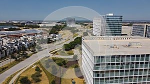 Group of office buildings with roadside luxury villas along Headquarters Drive, Legacy West, Plano, Texas to horizontal line