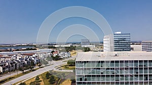 Group of office buildings with roadside luxury villas along Headquarters Drive, Legacy West, Plano, Texas to horizontal line