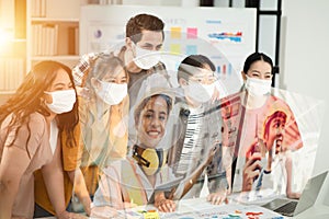 Group of office worker wearing mask having teleconference or video conference calls in the Covid 19 situation to avoid infection