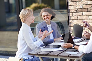 Group of office workers working on the terrace of the office. Teamwork concept