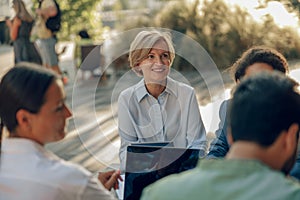 Group of office workers working on the terrace of the office. Teamwork concept . High quality photo