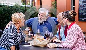 Group of old people eating and drinking outdoor - Seniors having fun