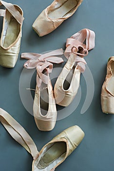 Group of old used pointe shoes.