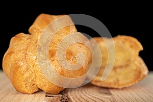 Golden baked profiterole  on black glass photo