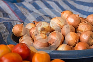 The group of onion in the tray on the table in the market