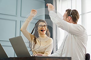 group of operator man and woman working with headset and laptop computer in a call centre . customer service help desk online.