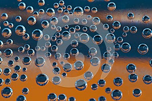 Group of orange and blue air bubbles in water
