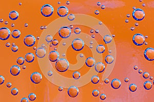 Group of orange and blue air bubbles in water