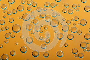 Group of orange and blue air bubbles in water