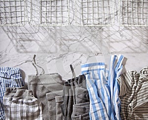 Group of organic cotton pyjamas set on white marble table is ready for folding and placing into white steel wire mesh
