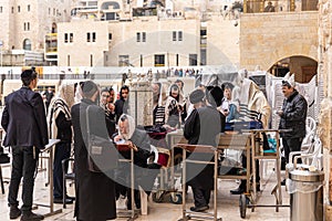 A group of Orthodox believers Jews conduct a joint prayer with the Torah Scrolls near the Kotel in the Old Town of Jerusalem in