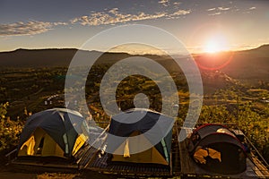 Group of outdoor lovers tourist tents set on high mountain facing to wide view