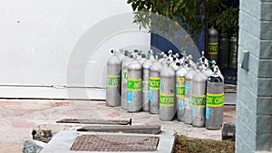 Group of oxygen, nitrox tanks for scuba diving in the sun waiting for tourists