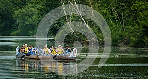 Group paddling down the Long Pond at the Toronto Islands. Tourists paddling on canoe on the river exploring territories