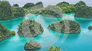 Group of Painemo Island surrounded by Blue Lagoon, Ocean, Raja Ampat, West Papua, Indonesia