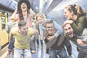 Group of party friends having fun in underground metropolitan station - Young people ready for night out  - Friendship and party