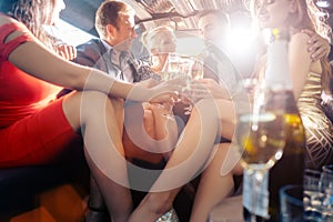 Group of party people in a limo drinking