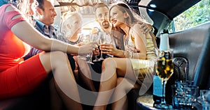 Group of party people in a limo drinking