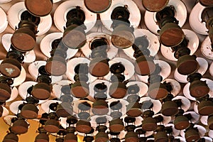 Group of pattern of old vintage storm lanterns, hurricane lamp hang on ceiling wood.