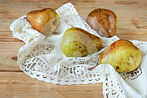 Group Pears  with napkin on wooden background, closeup, top view, autumn harvest concept