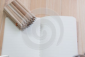 Group of Pencil put on empty notebook