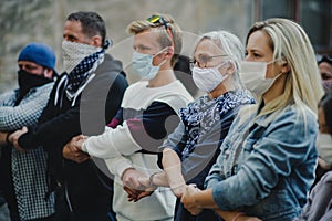 Group of people activists protesting on streets, march and demonstration concept.