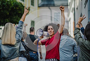 Group of people activists protesting on streets, strike, demonstration and coronavirus concept.