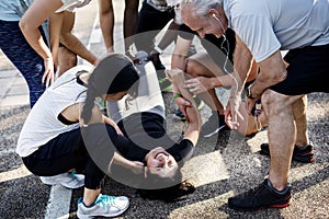 Group of people assisting an injured person photo