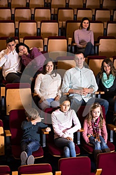 A group of people attentively watching interesting film