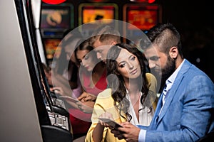 Group of People at Automat Machine in Casino