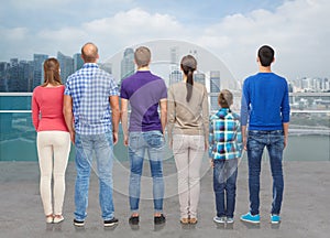 Group of people from back over city waterside photo