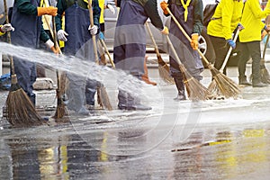 Group of people big cleaning praying water to clean the road