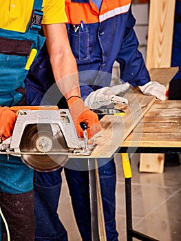 Group people builder with circular saw