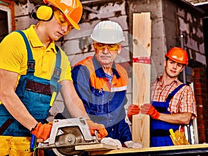 Group people builder with circular saw