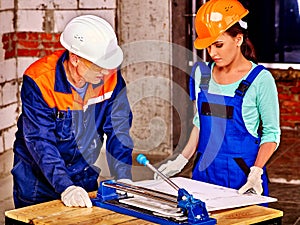 Group people builder cutting ceramic tile