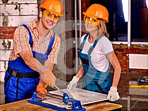 Group people builder cutting ceramic tile.