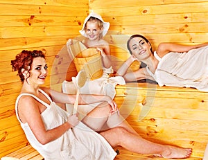 Group people with child in sauna.