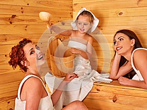 Group people with child in sauna