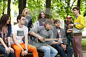 Group of people in city park listen music.