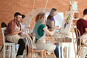 Group of people during classes in school of painters photo