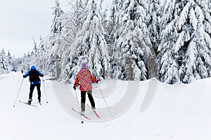 Group of people cross country skiing on beautiful winter day. Cross-Country Skiing in Germany, in snowy forest.